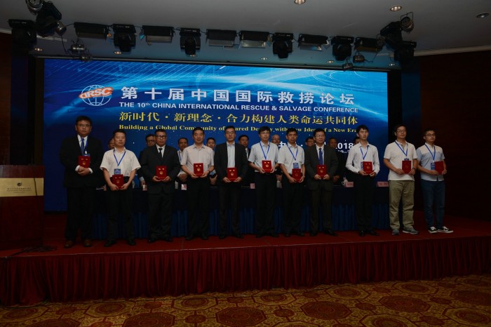 Photo: Excellent Paper authors obtain certificates on stage.